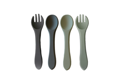 Set of four plastic utensils including two forks and two spoons on a white background