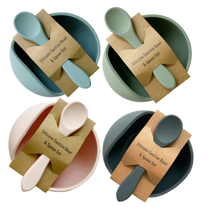 Four silicone suction bowl and spoon sets in different colors with packaging on a white background.